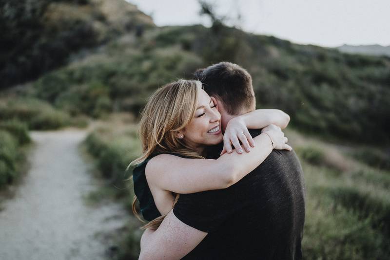 Couple cuddles during engagement session in los angeles canyon