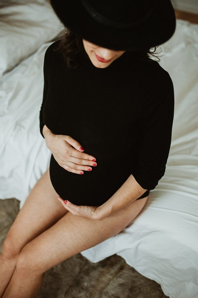 Pregnant woman with black bodysuit during maternity photoshoot in brooklyn home