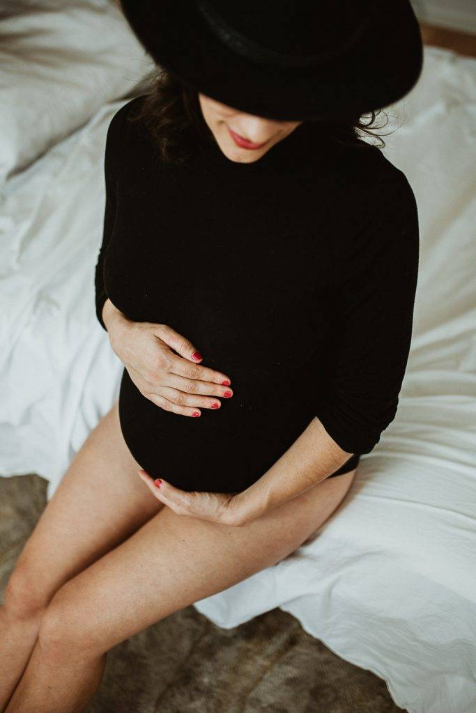 Pregnant woman with black bodysuit during maternity photoshoot in brooklyn home