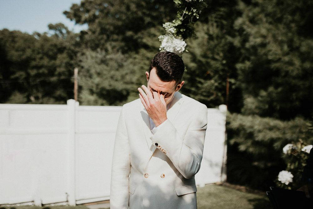 Groom cries at wedding ceremony in the hamptons