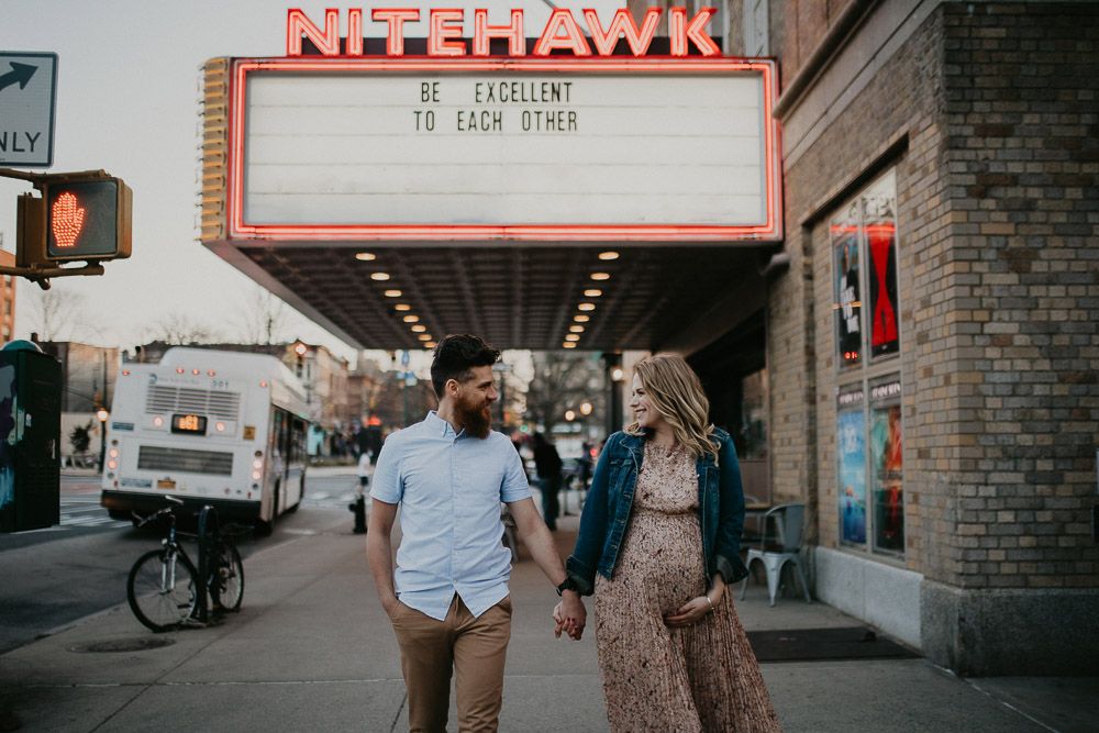 Couple in front of old cinema during maternity photoshoot in prospect park brooklyn