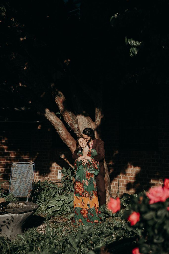 Couple snuggling in brooklyn backyard during elopement
