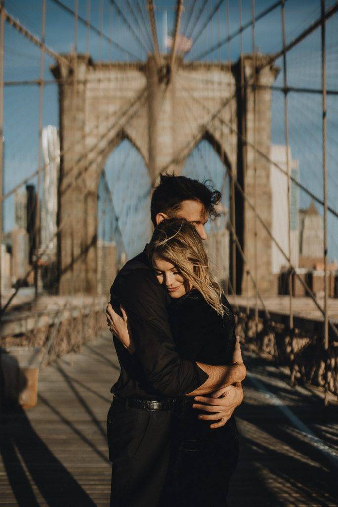 Couple on brooklyn bridge at sunrise during elopement photoshoot
