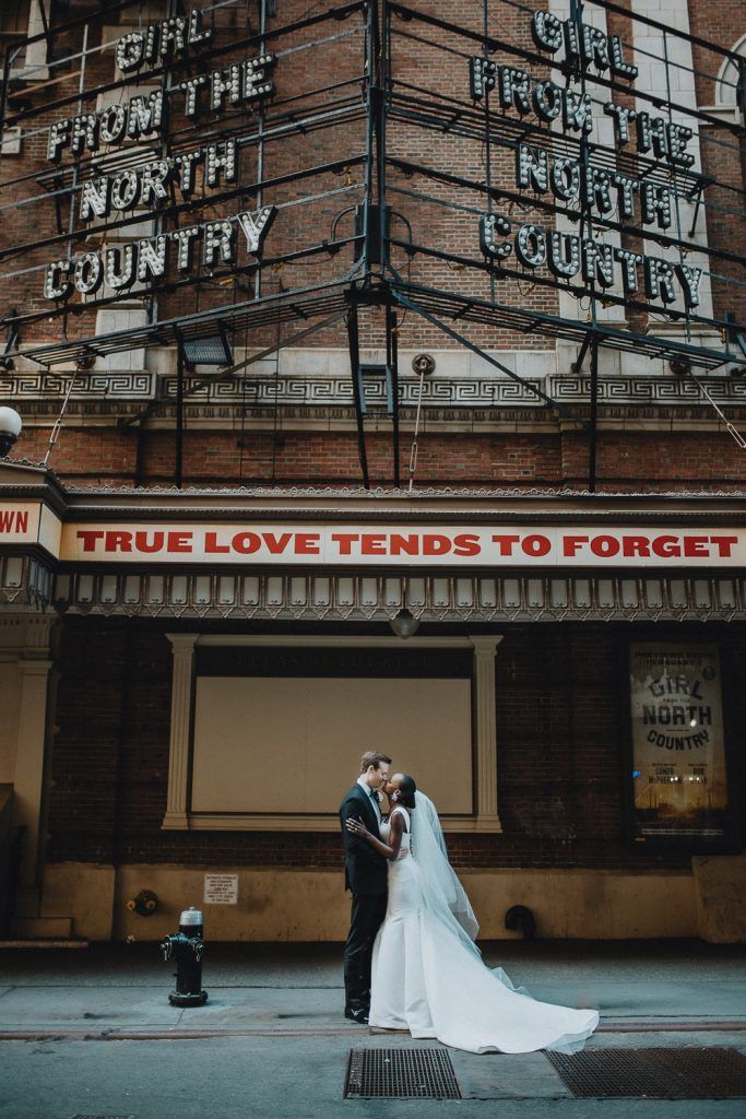 Interracial bride and groom at nyc wedding in theatre district