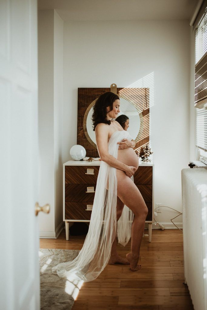 Naked pregnant woman during maternity photoshoot at home in brooklyn