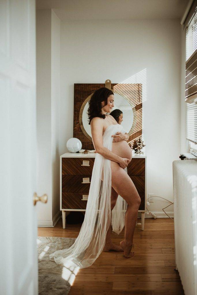 Naked pregnant woman during maternity photoshoot at home in brooklyn