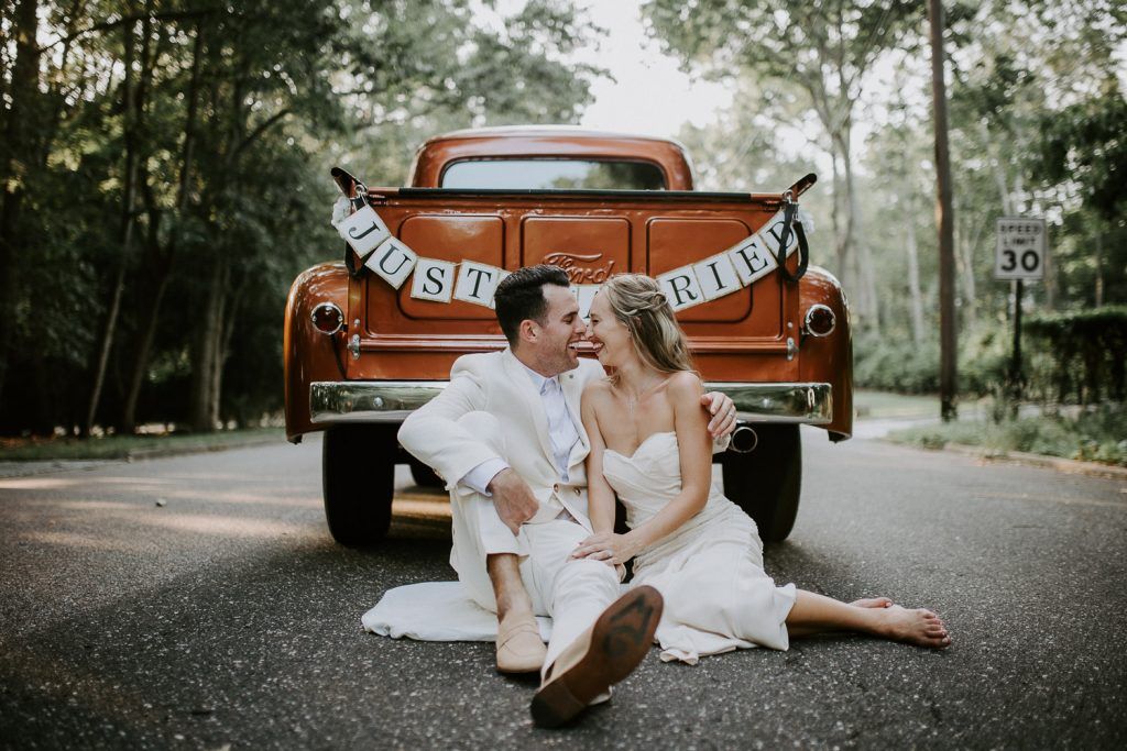 Bride and groom in vintage Ford truck at hamptons wedding