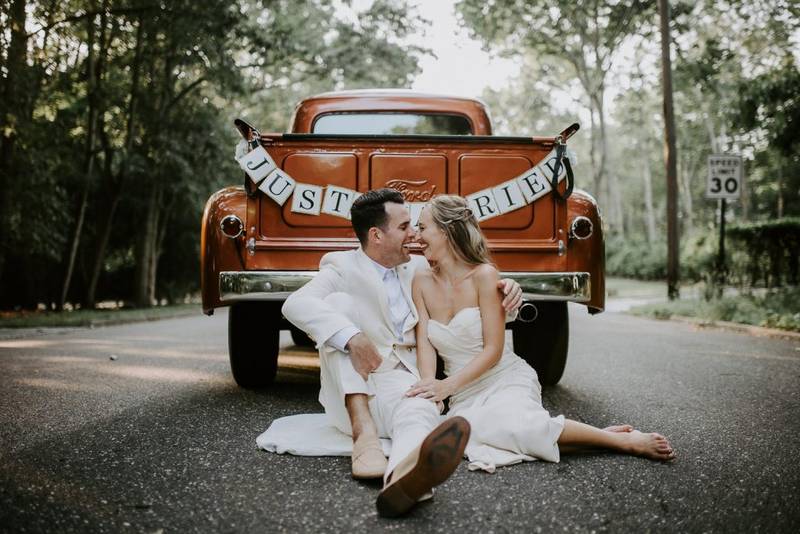 Bride and groom in vintage Ford truck at hamptons wedding