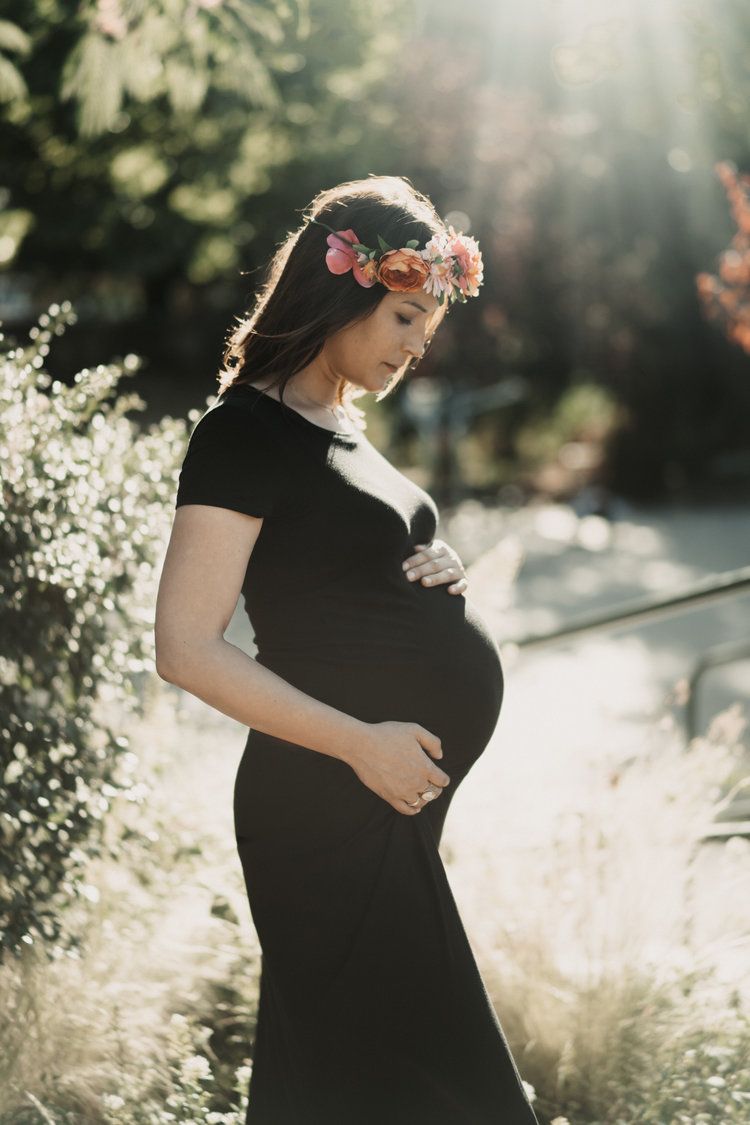 Pregnant woman with flower crown during outdoor maternity session in brooklyn