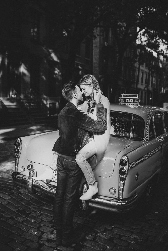 Couple by old taxi cab during nyc engagement photoshoot