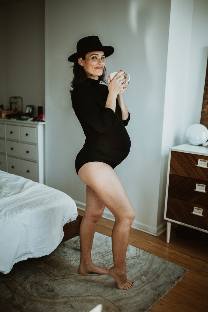Pregnant woman with black bodysuit during maternity photoshoot in brooklyn home