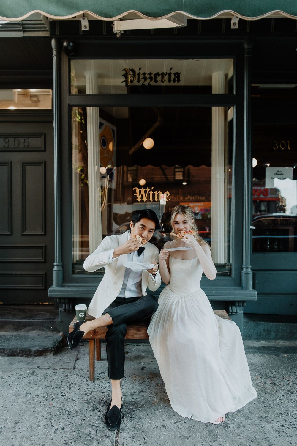 Bride and groom eating pizza during nyc elopement