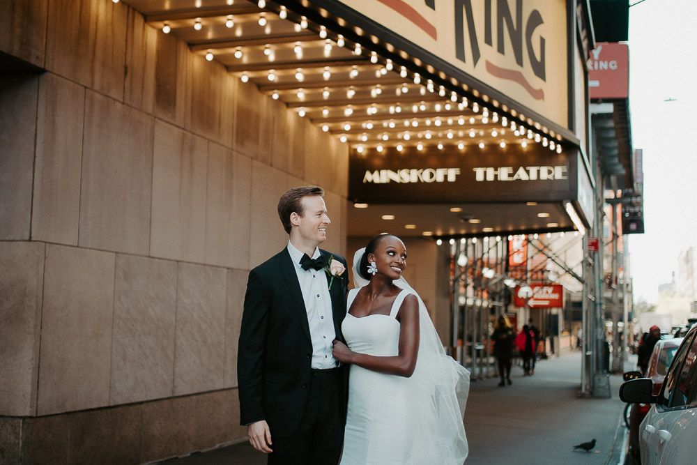 Interracial bride and groom at nyc wedding in theatre district