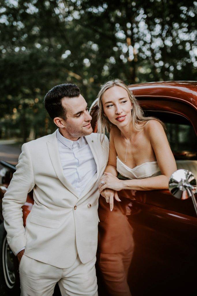 Bride and groom in vintage Ford truck at hamptons wedding