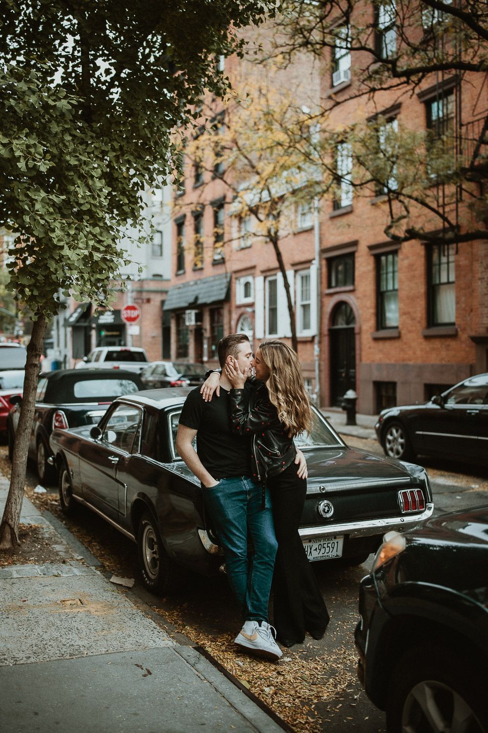 Couple by old car during engagement photoshoot in the west village of nyc