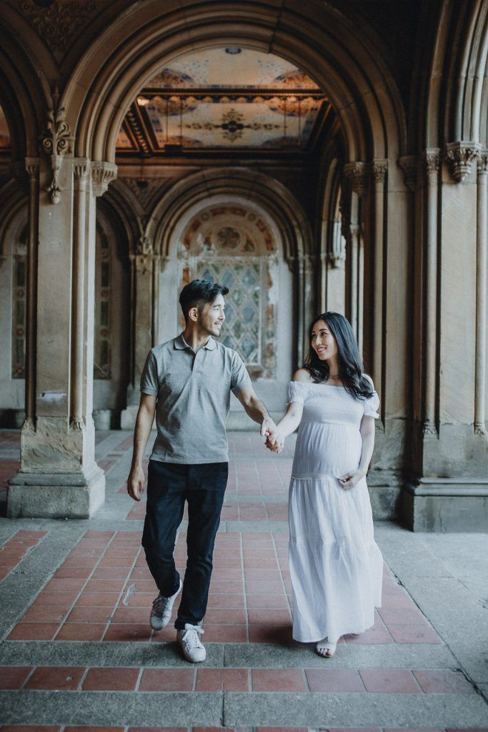 Expecting couple in central park at bethesda terrace during maternity photoshoot