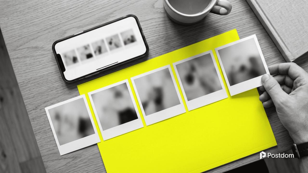 A phone showing a row of square photos beside five printed photos laid out in order on a yellow folder, a hand placing the last one