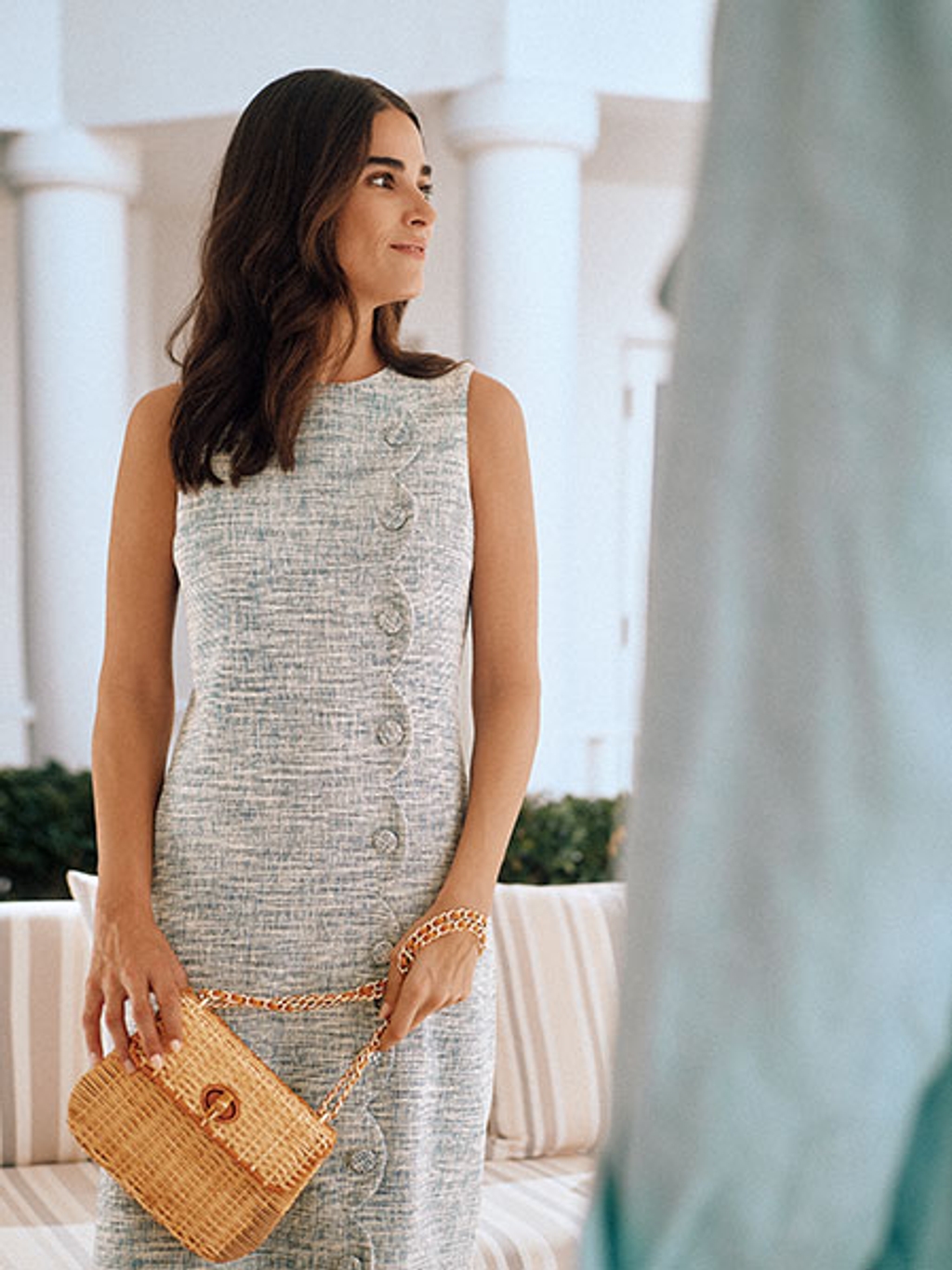 Model in tweed dress with wicker bag