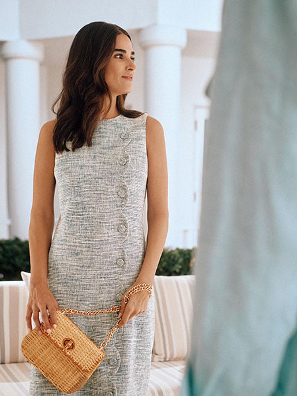 Model in tweed dress with wicker bag