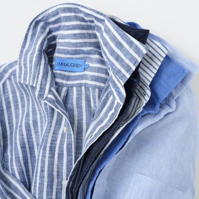 tight cropped in laydown of mens linen sport shirts in various shades of blue and different patterns