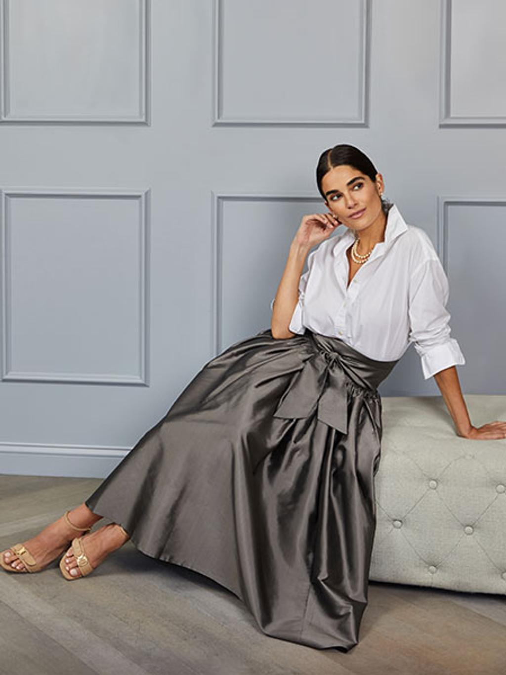 Model wearing white shirt and gunmetal ball skirt