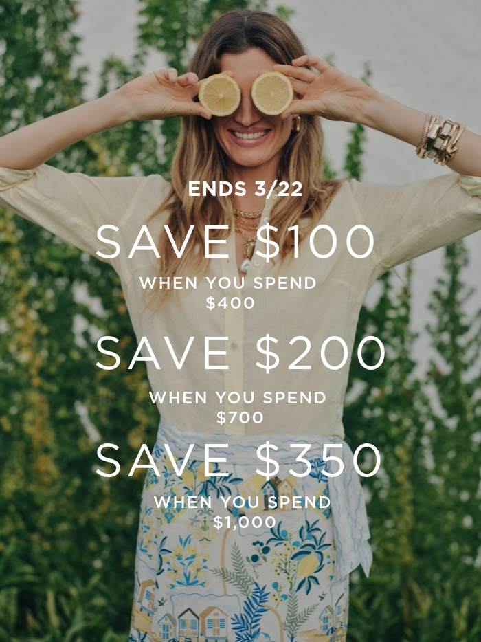 woman wearing yellow linen shirt and playfully holding lemon slices over her eyes