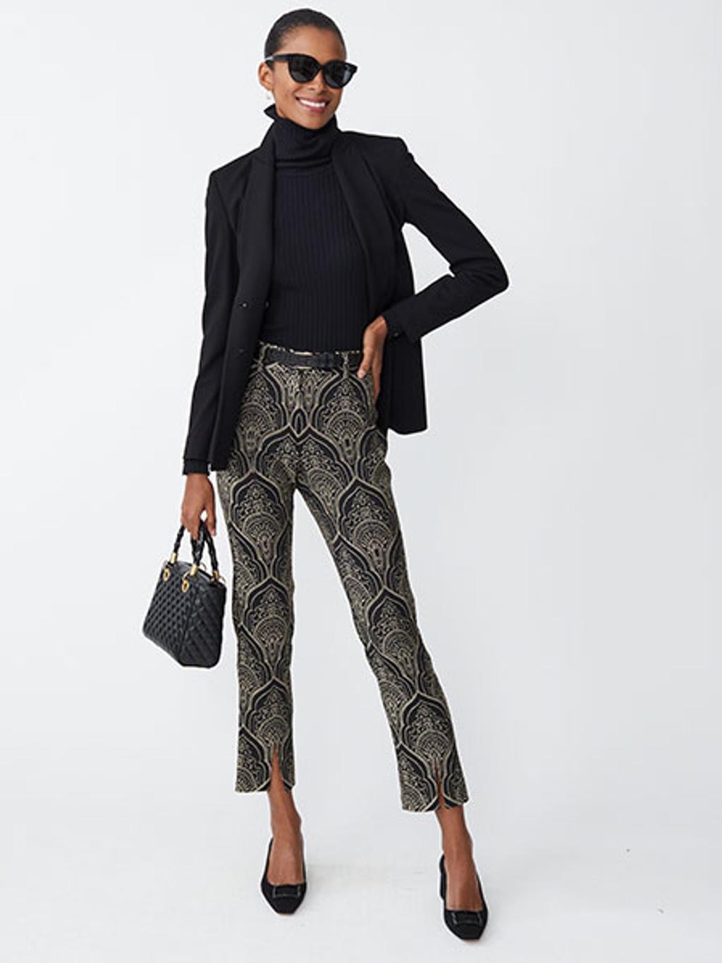 Model wearing black turtleneck and black-and-gold jacquard pants Model wearing black turtleneck and black-and-gold jacquard pants