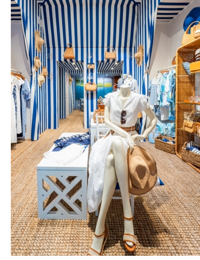interior of womens lifestyle boutique shop with blue and white striped cabana motif
