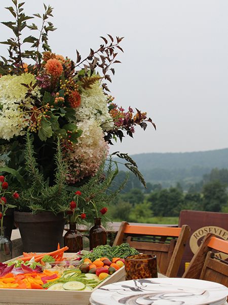 Table setting with crudité platter, ceramics, and flowers