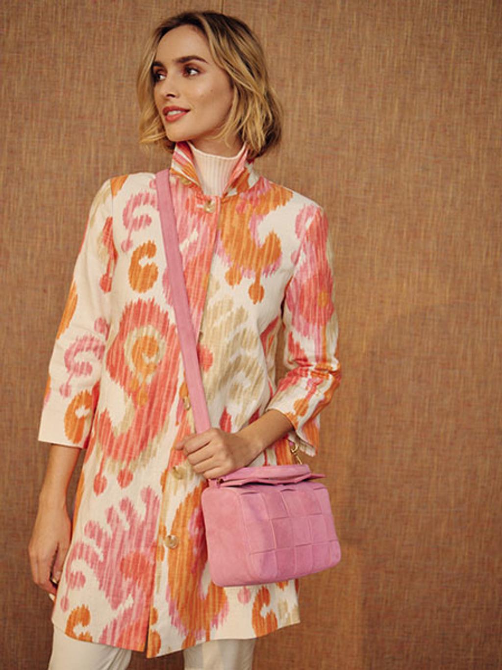 Model in ikat coat with crossbody bag