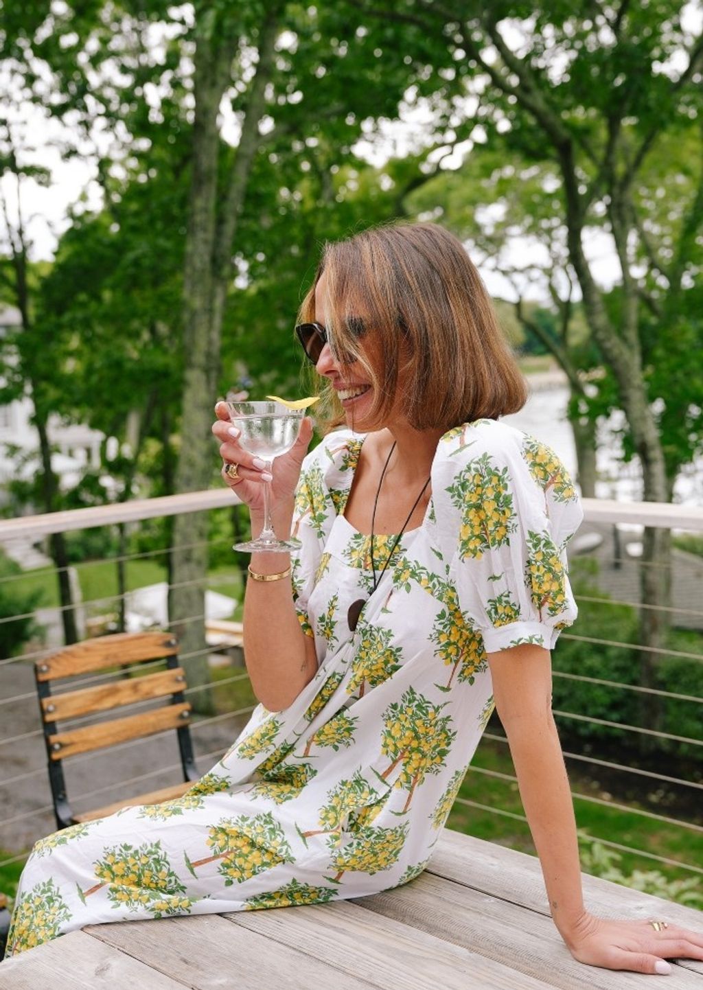 woman seated wearing a lemon patterned dress