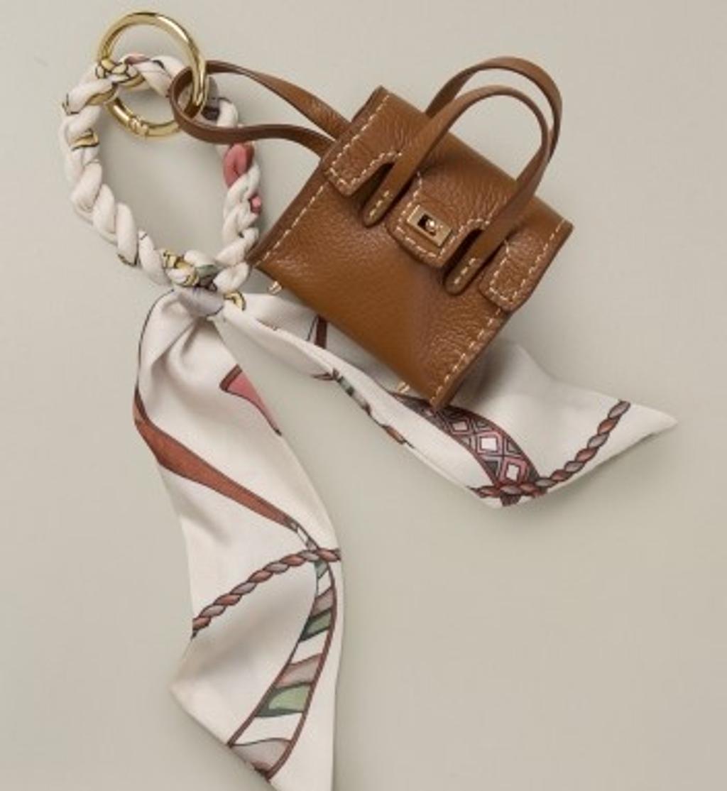 Light beige faux fur collar with a red and cream equestrian-patterned silk scarf.