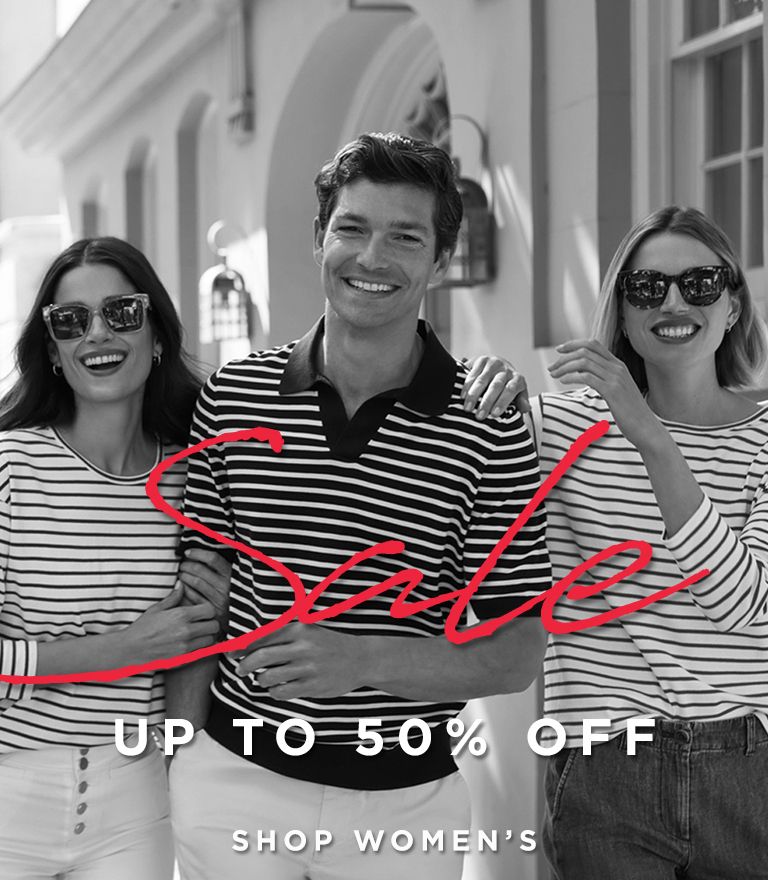 Three smiling models wearing striped tops stand arm-in-arm outdoors, promoting a fashion sale. Text overlaid reads 'Sale - Up to 50% Off' with links to 'Shop Women's' and 'Shop Men's.'