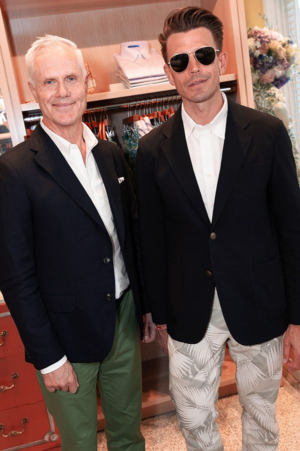 Two men pose together for photo