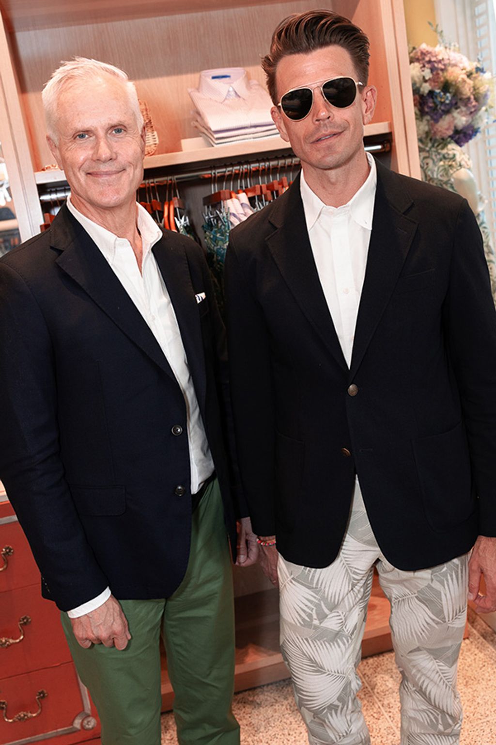 Two men pose together for photo