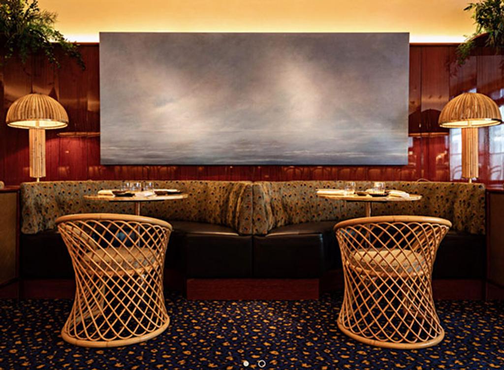 Interior of Le Bar des Pres with banquettes and rattan chairs Interior of Le Bar des Pres with banquettes and rattan chairs