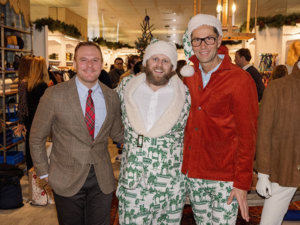 Three men dressed in festive holiday attire.