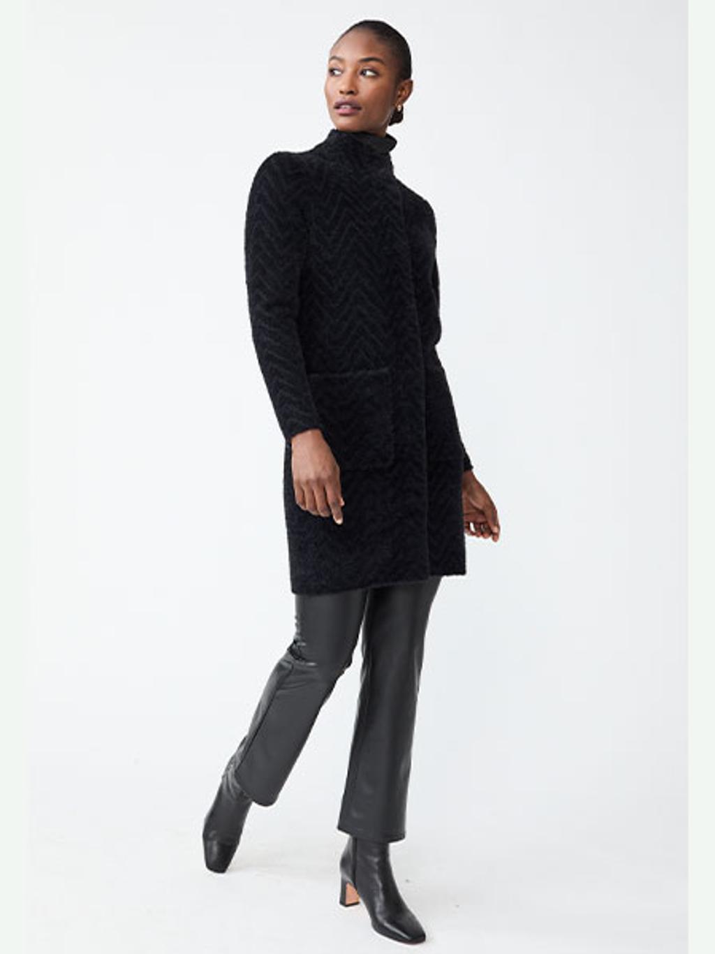 Model wearing sweater coat, faux leather pants, and ankle boots Model wearing sweater coat, faux leather pants, and ankle boots