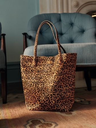 womens leopard tote bag positioned in living room