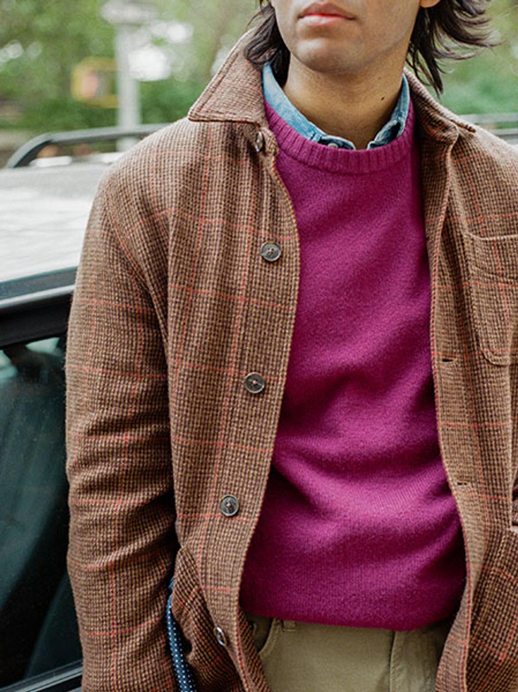 Model wearing a purple crewneck sweater and button down jacket.