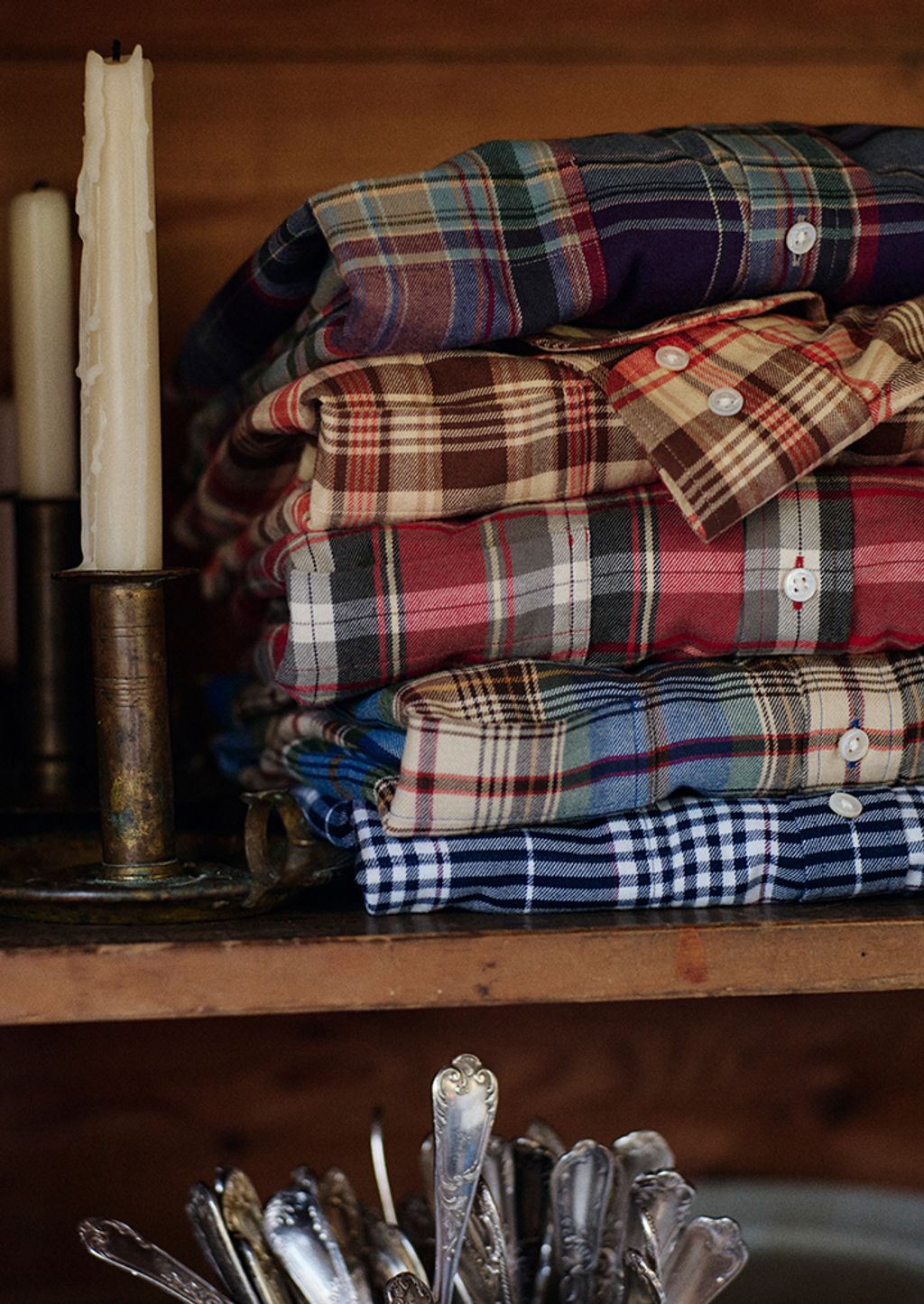 Stack of men's button up flannel shirts.