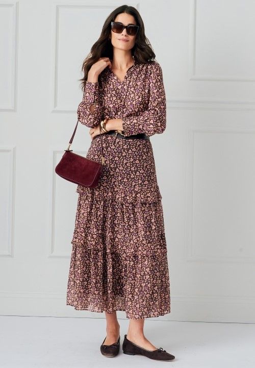 woman standing wearing micro floral pattern tiered midi skirt with matching romantic boho style blouse