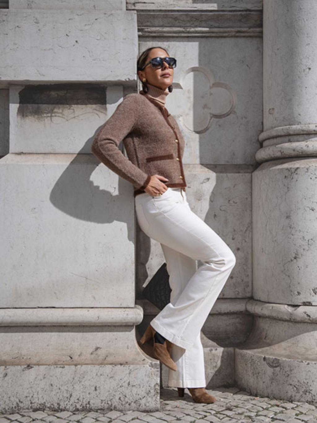 Filipa in brown cardigan, camel turtleneck, white jeans, and brown boots Filipa in brown cardigan, camel turtleneck, white jeans, and brown boots