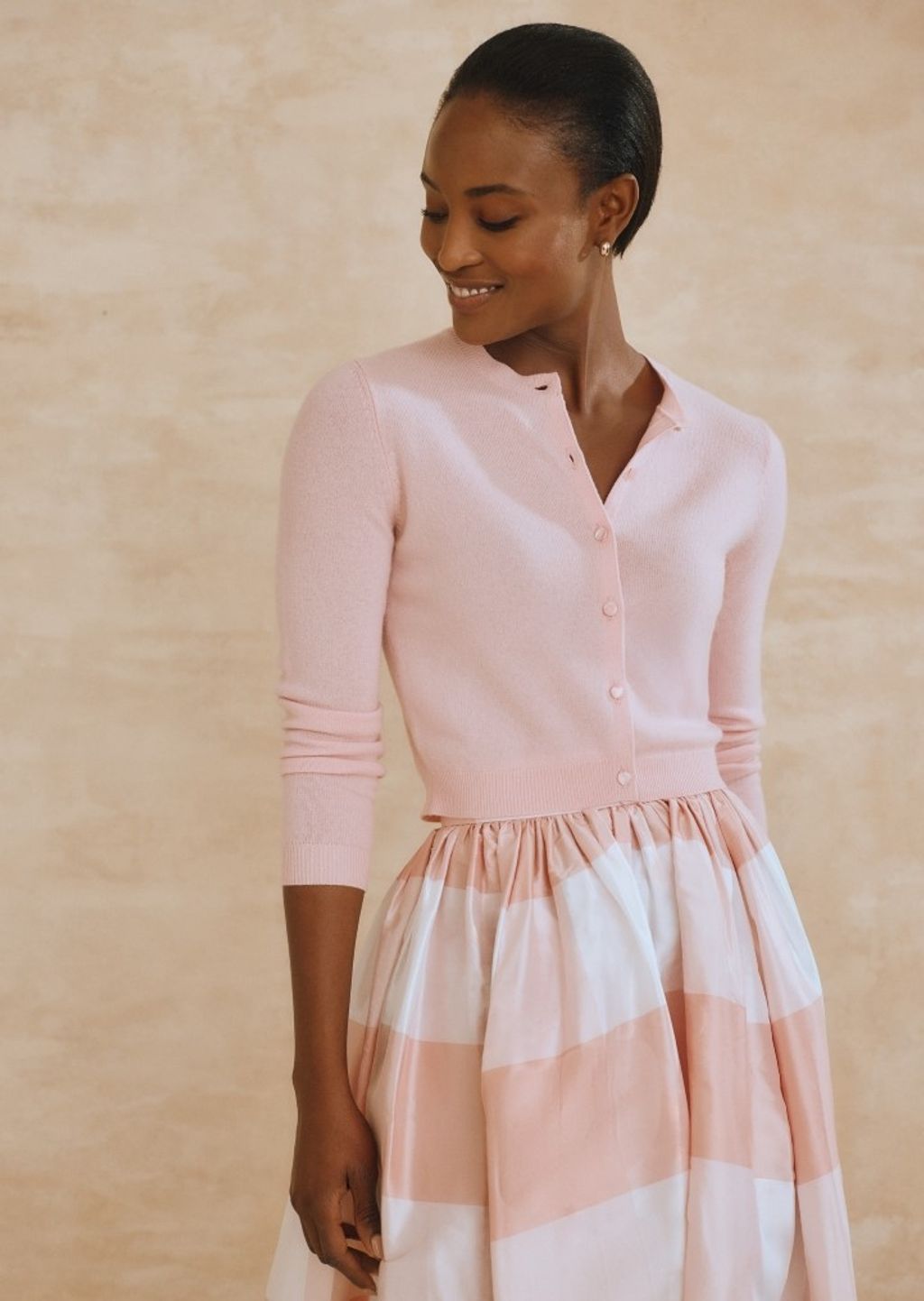 woman wearing a pale pink cashmere cardigan