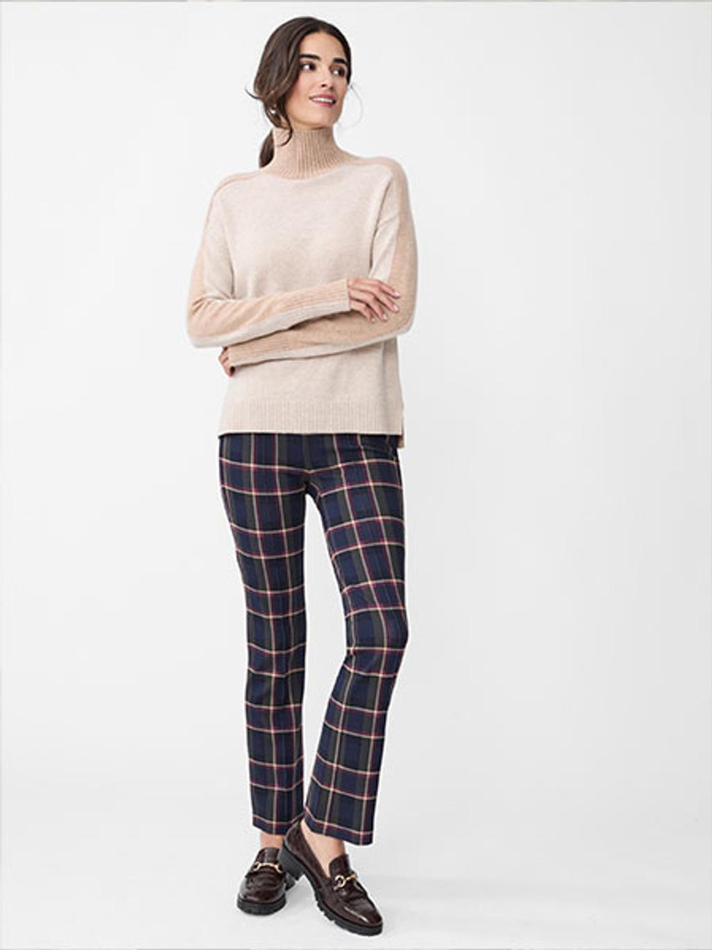 Model wearing plaid pants and color-block turtleneck