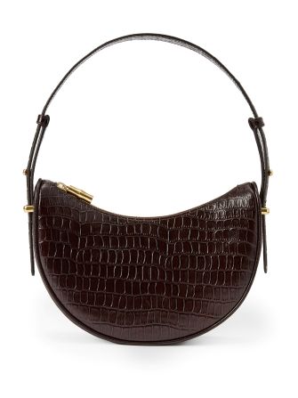 still life of womens brown croc embossed leather shoulder bag