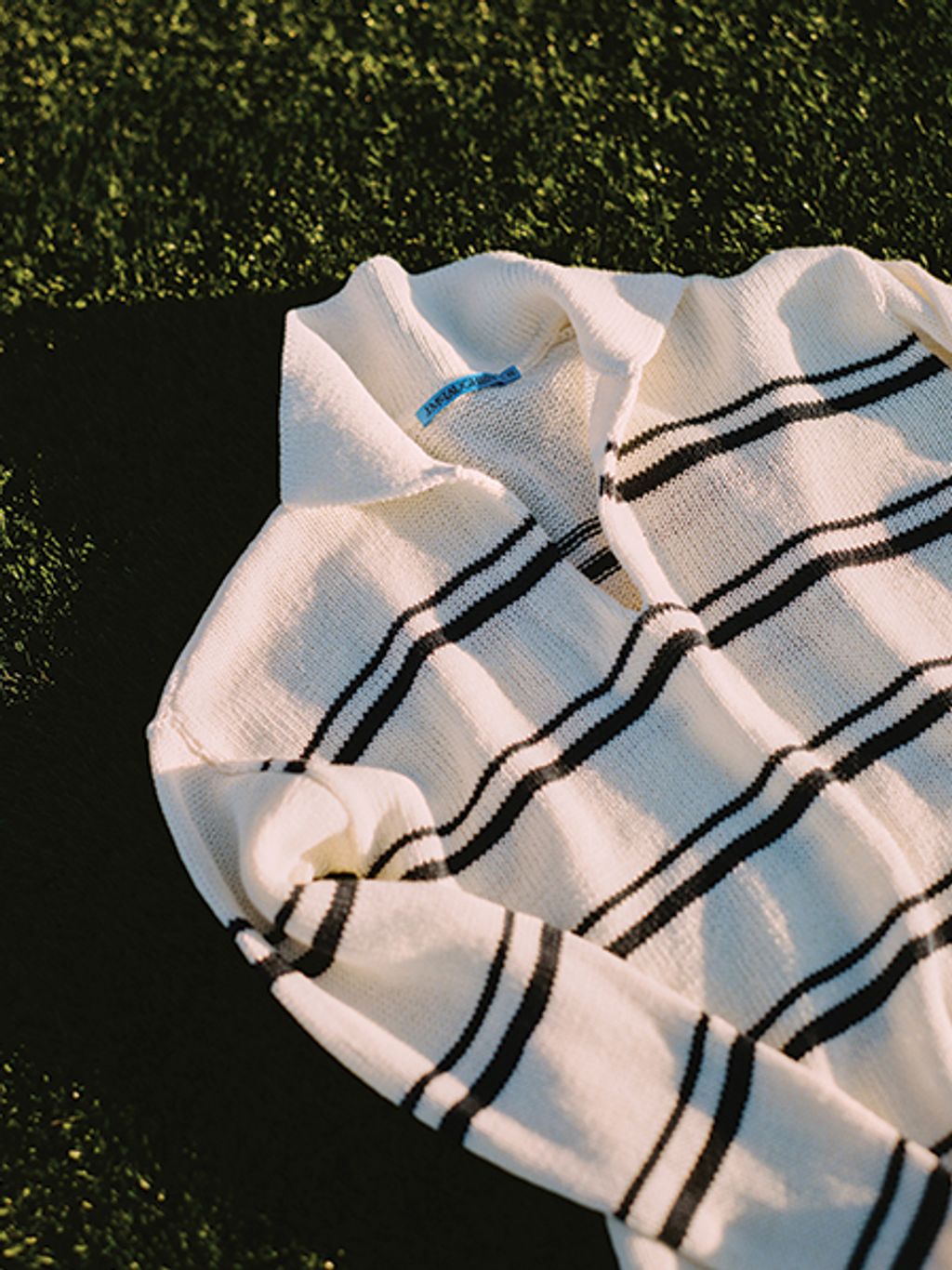 Striped sweater on grass