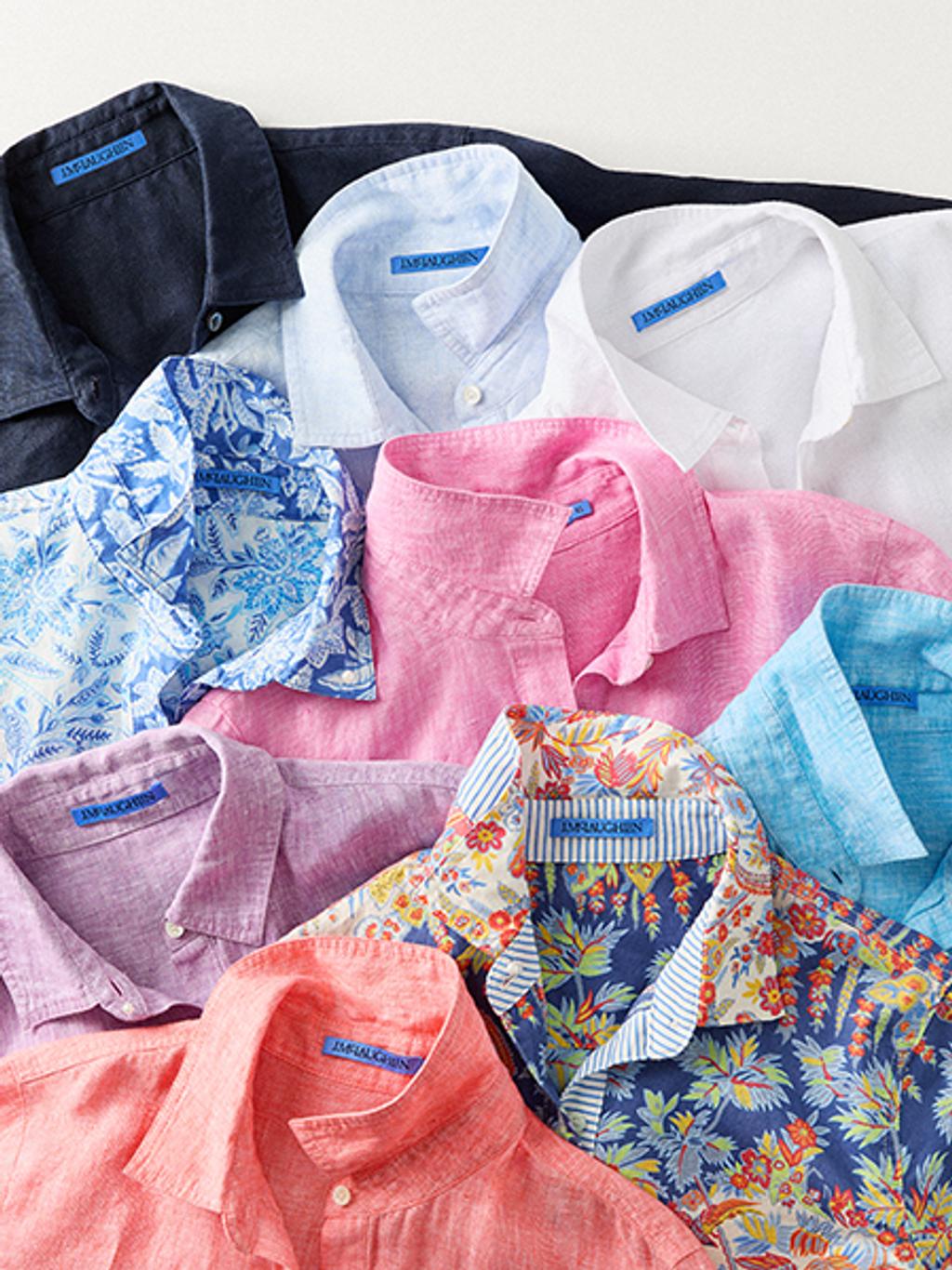 Flatlay of multiple, colorful collard shirts