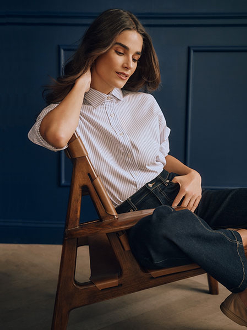 Model in striped shirt and wide-leg jeans Model in striped shirt and wide-leg jeans