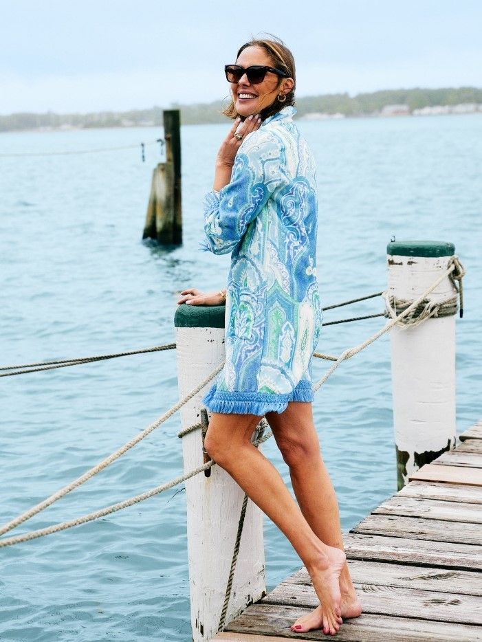 woman standing on a pier wearing a paisley terry coverup dress